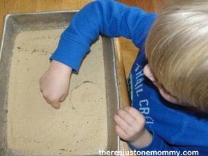 practicing writing letters in sand