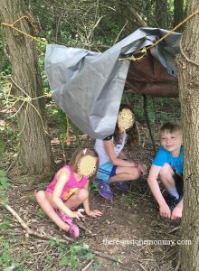 teaching kids survival skill with building a shelter