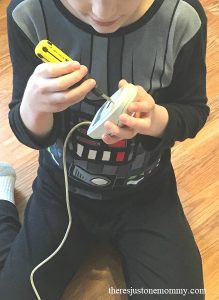 upcycled STEM activity: child taking apart computer pieces